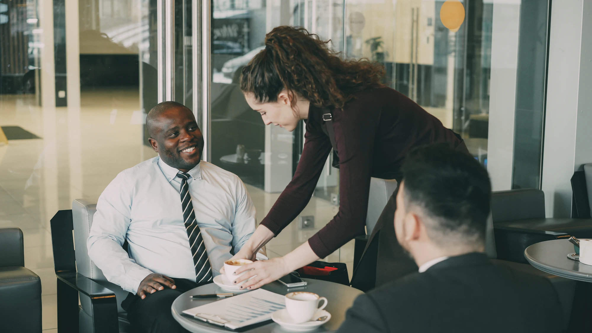 An attorney meeting a client team around a low table