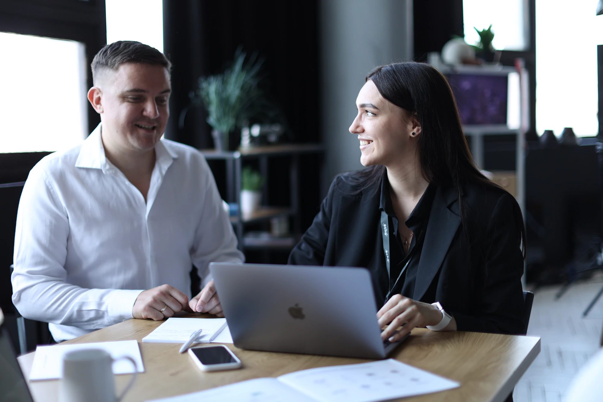 A lawyer and a client discussing an agreement over a laptop