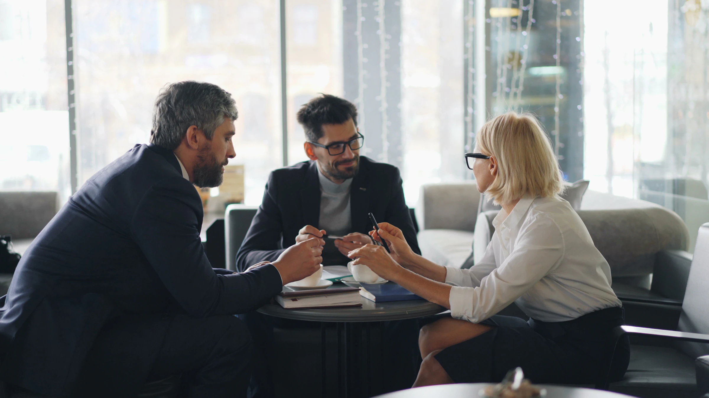 An attorney and clients talking through progress around a low table